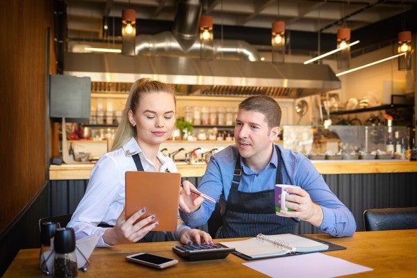 Restaurant owners discussing their marketing plan.