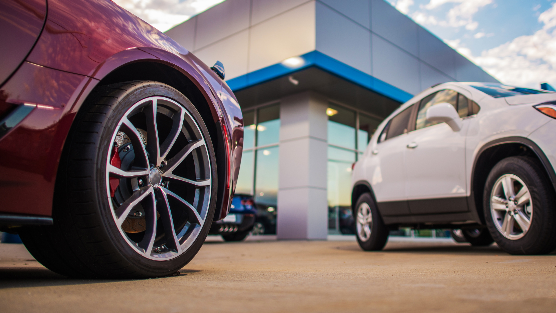 Car dealership exterior with close up shot of car wheels